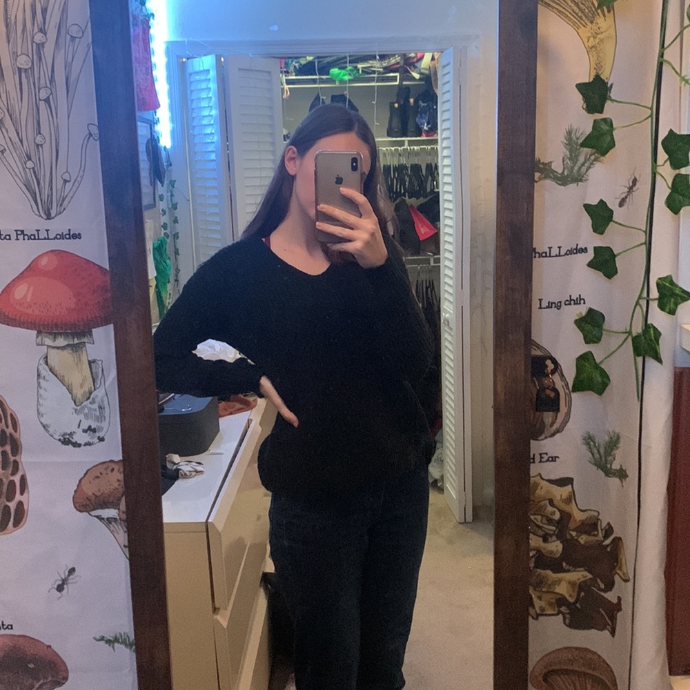 Black knit sweater with a braided back